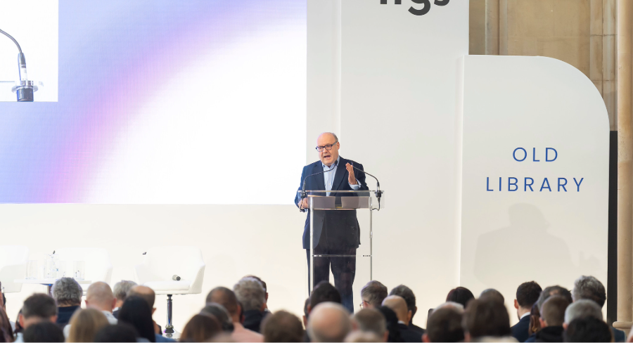 Chris Hawards on stage at IFGS 2026, discarding legacy tie for fintech innovation