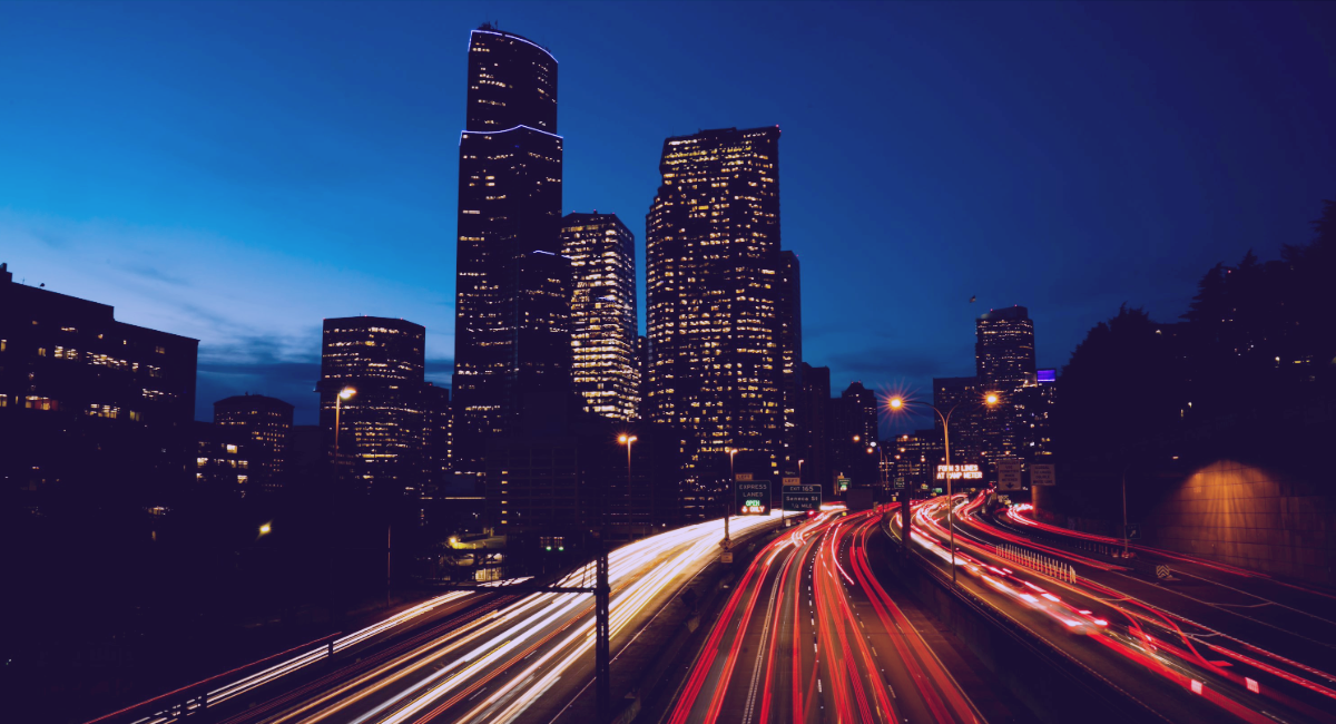 Nighttime city scene with light trails from fast‑moving traffic, illustrating rapid product updates and agility for evolving private‑credit and alternative‑finance strategies.